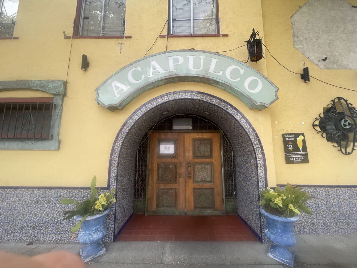 Alameda Post - The entrance to a restaurant with a sign that says Acapulco over the front.