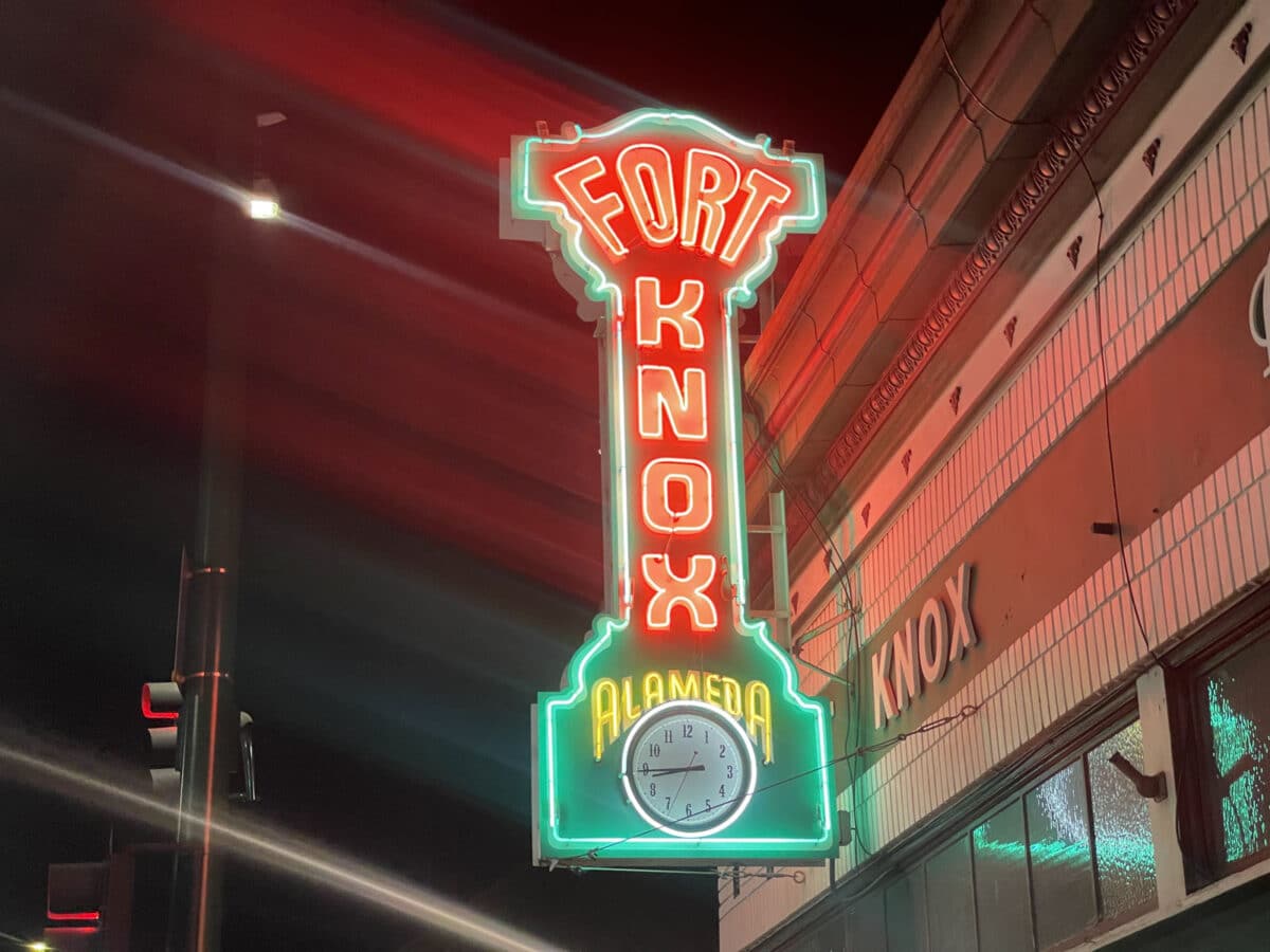 Alameda Post - A multicolored neon sign with a clock that says Fort Knox Alameda.