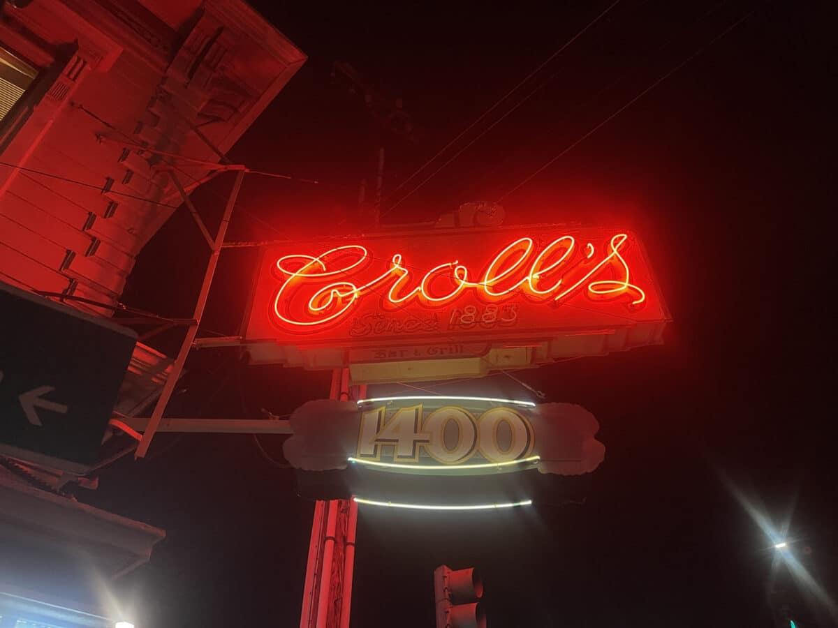 Alameda Post - A bright red neon sign that says "Croll's"