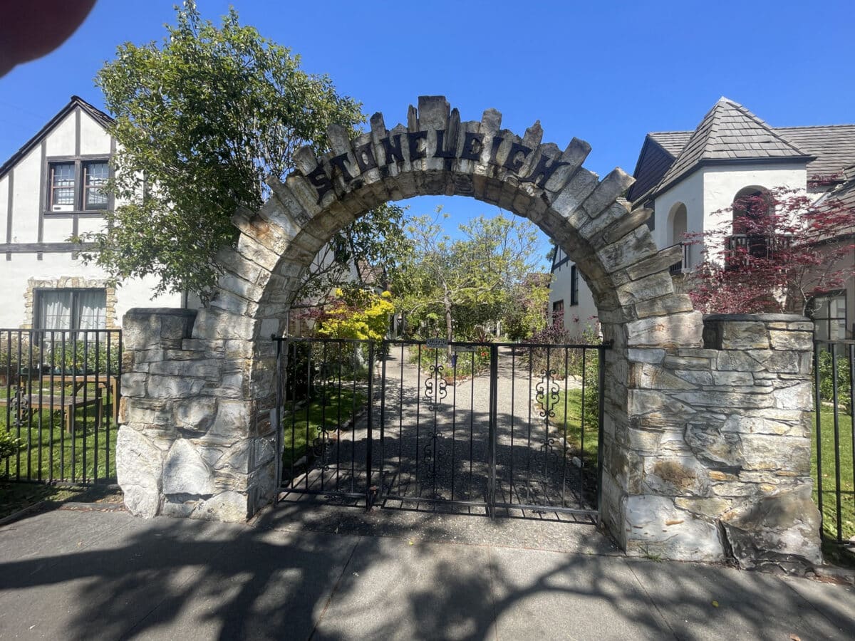 Alameda Post - A grand stone archway in front of a complex of houses. On the arch is a word, "Stoneleigh"