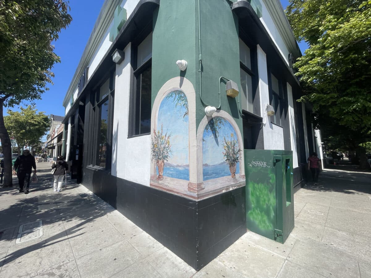 Alameda Post - Murals on two adjoining walls of a building that look like windows. 