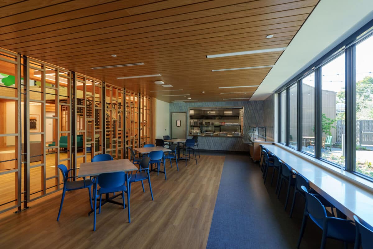 Alameda Post - A small, cafeteria like dining area with seating and a serving area built into the wall. 