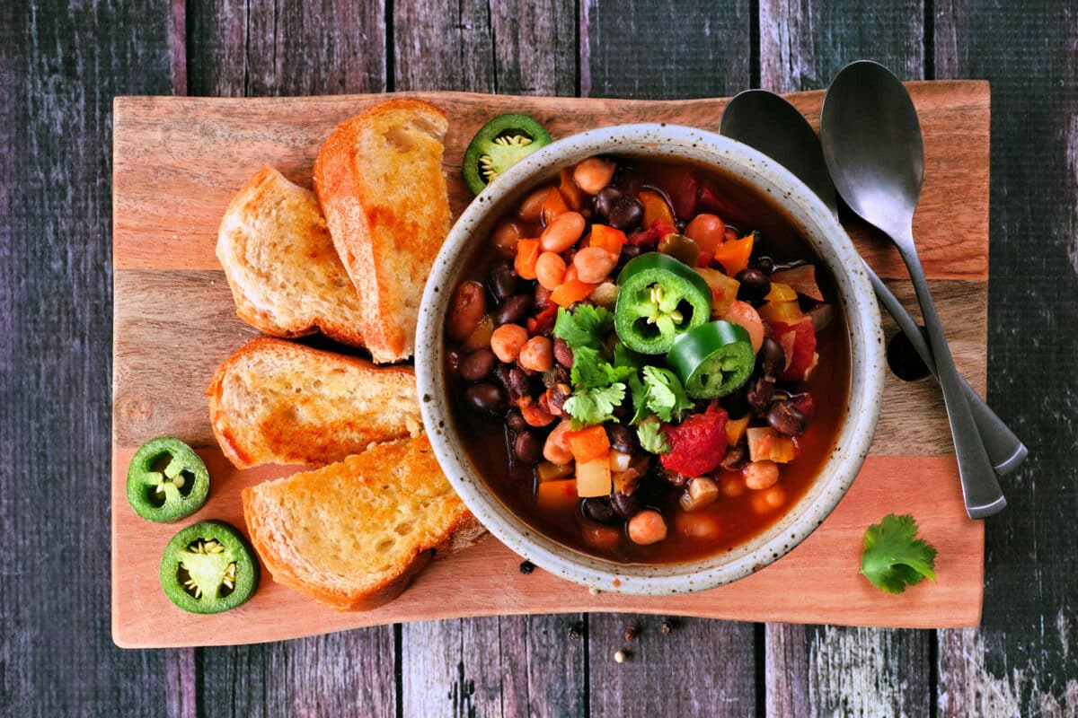 Alameda Post - A bowl of bean chili with a side of bread.