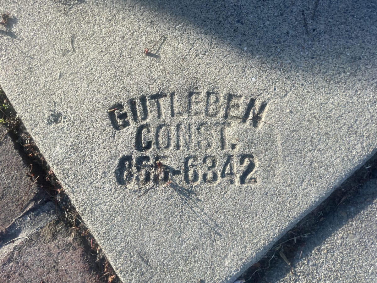 Alameda Post - A stamped sidewalk brand with a phone number and brand name.
