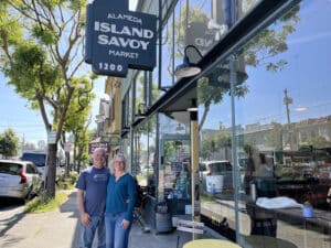 Alameda Post - A man and woman smile outside of Island Savoy.