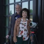 Alameda Post - Robert Campos and Donna LoCicero smile next to a camera.