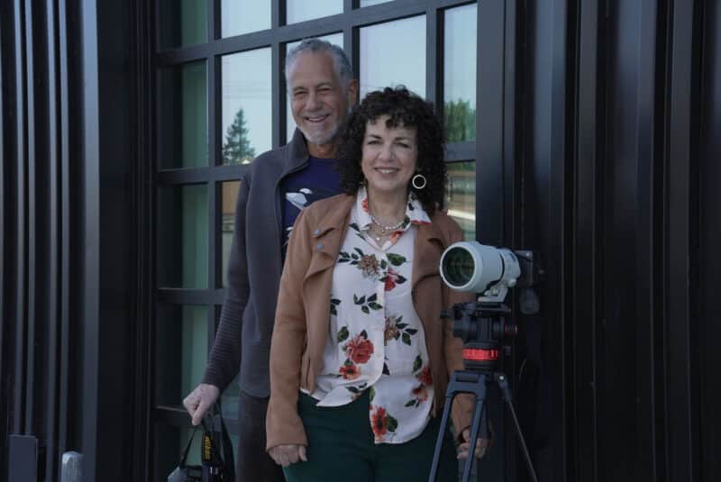 Alameda Post - Robert Campos and Donna LoCicero smile next to a camera.