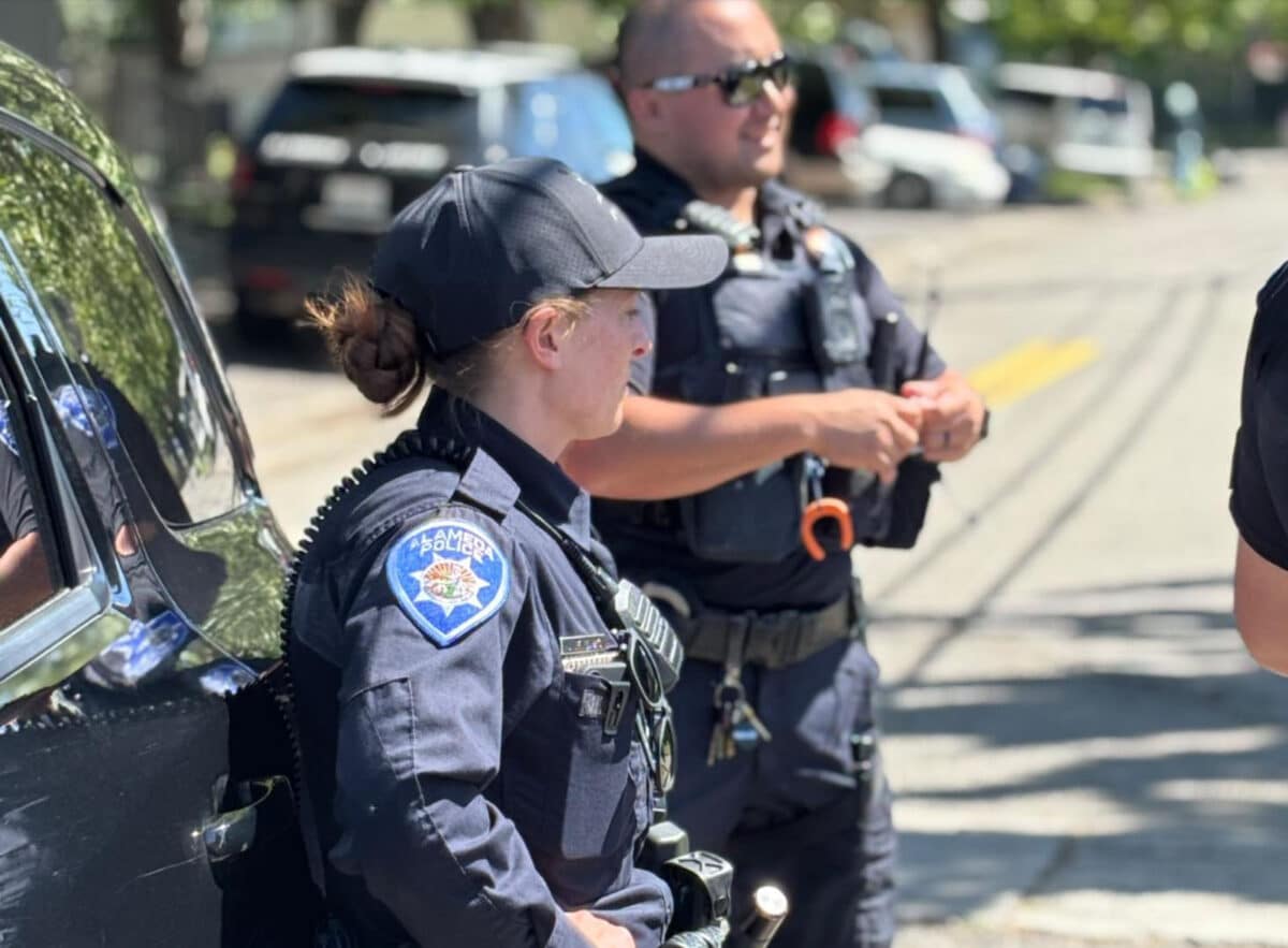 Alameda Post - A.P.D. officers gather together and talk with one another on the road.