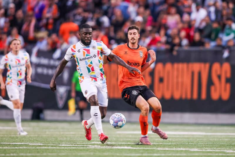 Alameda Post - An Oakland Roots player dribbles the ball in a match against Orange County S.C.