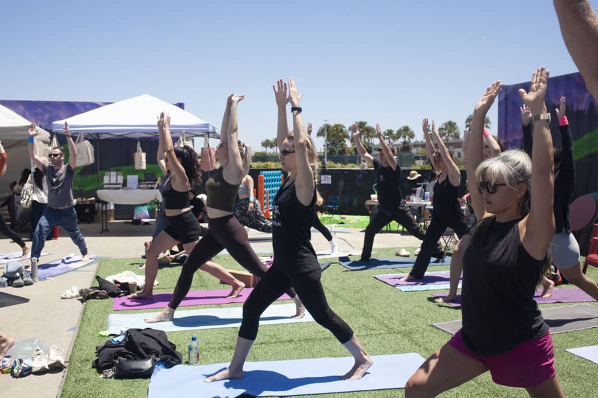 Alameda Post - People strike a yoga pose on mats at the Alameda Yoga & Wellness Festival.