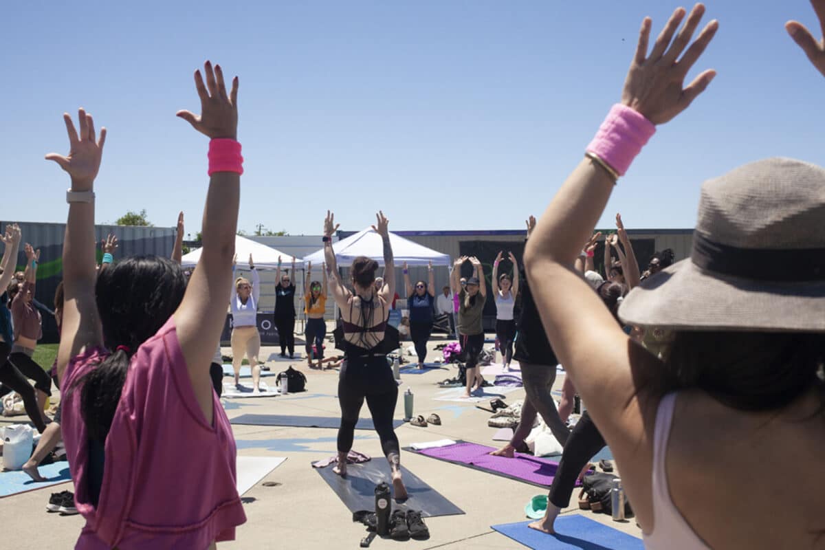 Alameda Post - A group of yoga practitioners pose on their yoga mats in a circle at Radium Runway.
