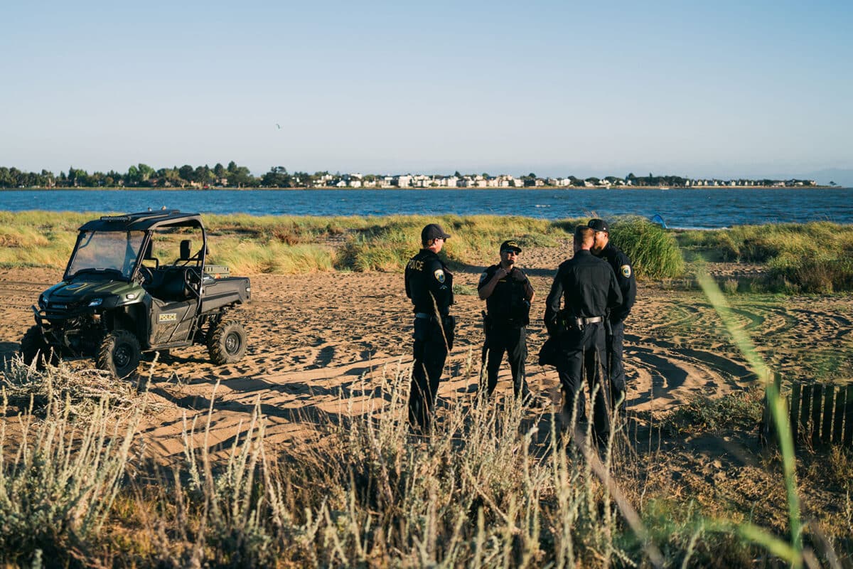 Alameda Post - an ATV parked next to police officers on the beach
