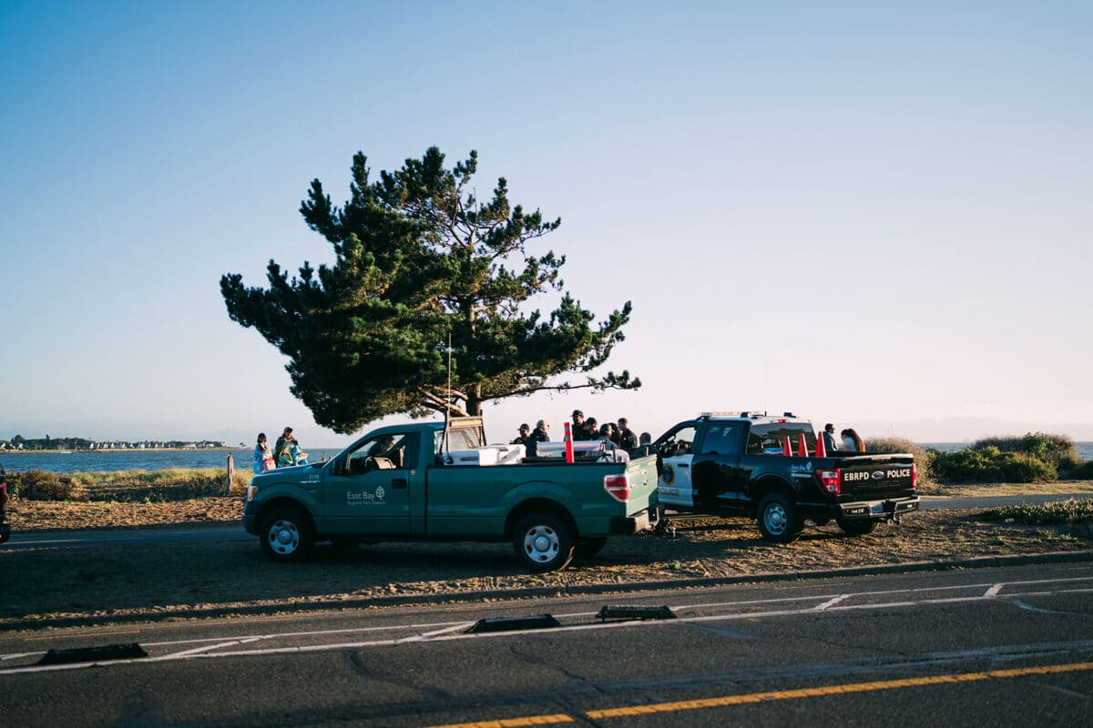 Alameda Post - Two East Bay Regional Parks District vehicles parked on the beach next to police officers.