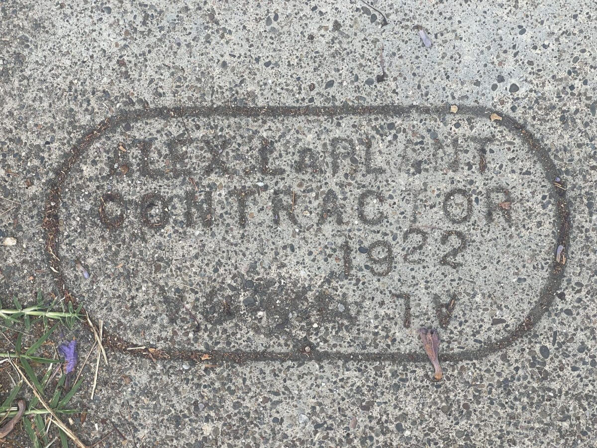 Alameda Post - a curb stamp with the name of a contractor and the year 1922. 