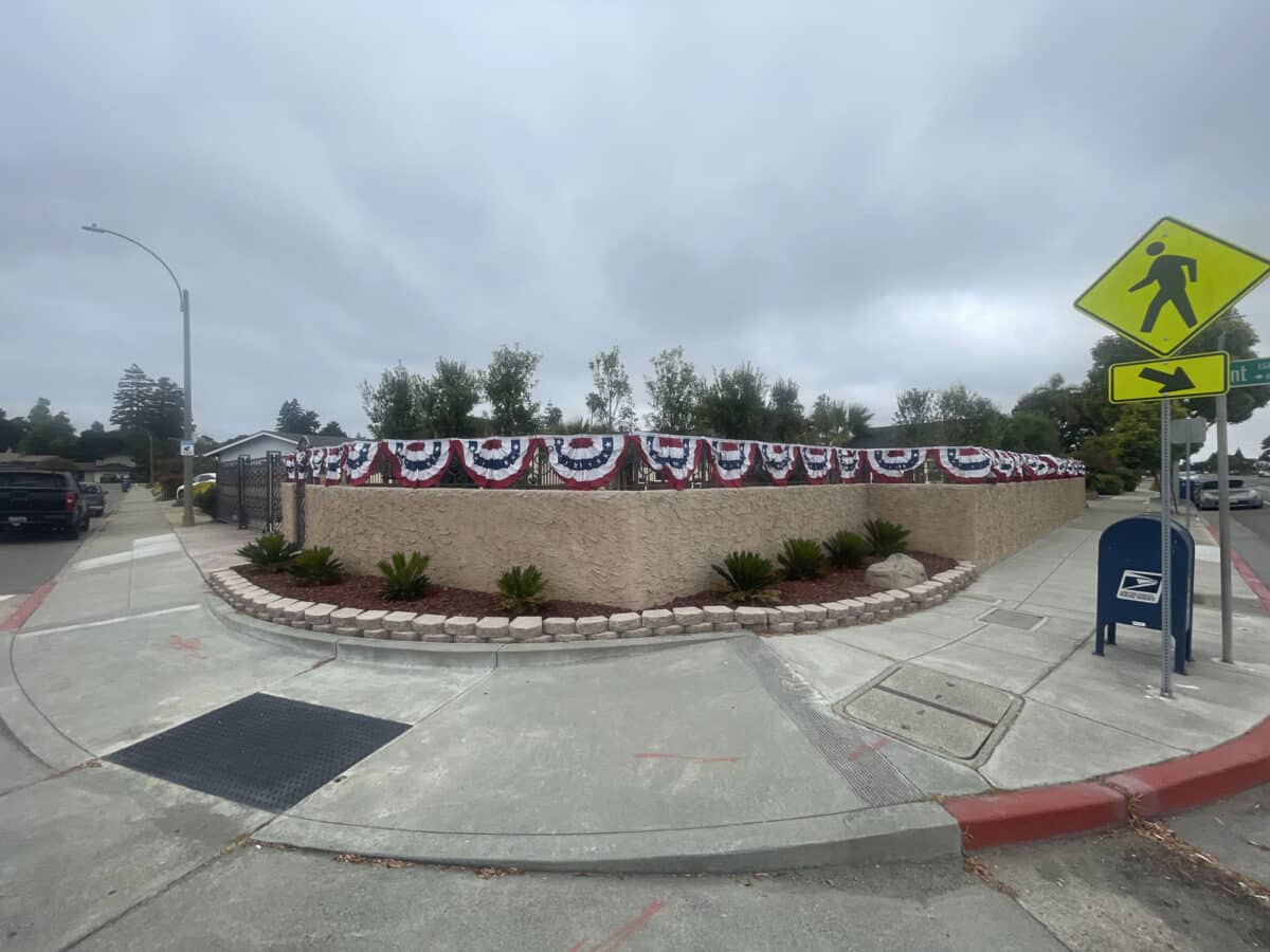 Alameda Post - A fence with red, white, and blue bunting. 