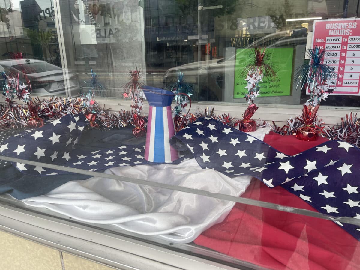 Alameda Post - A patriotic window display with flags and decorations. 