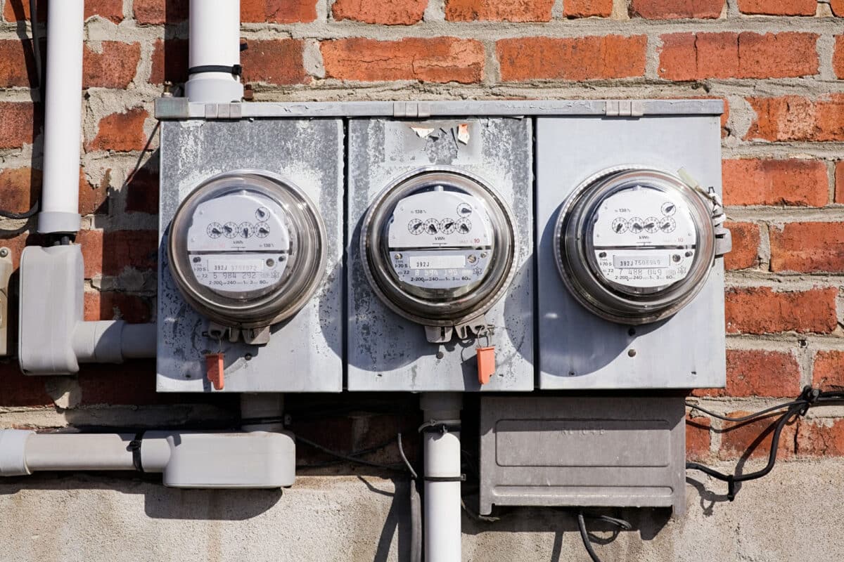 Alameda Post - Three side by side electricity meters on a brick wall. 