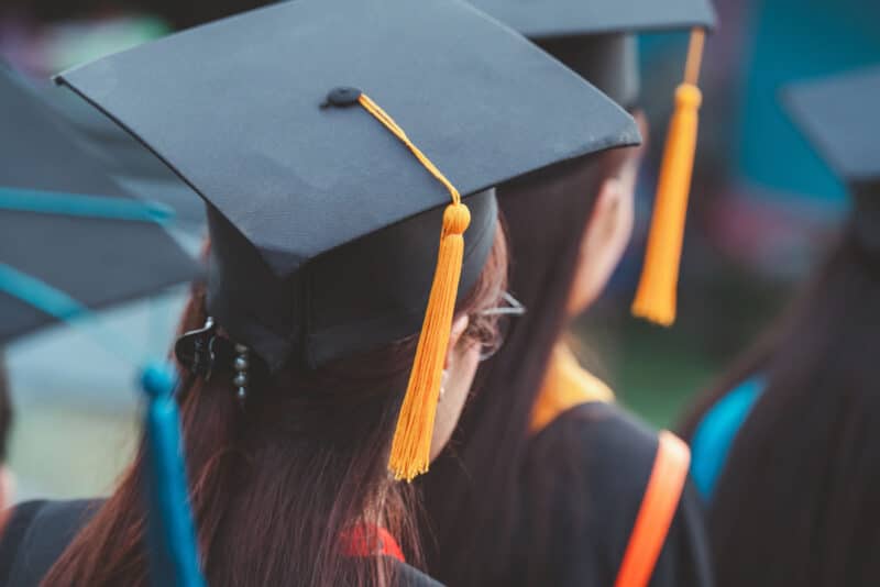Alameda Post - The back of a woman's head during graduation. She is wearing a claw clip and a graduation cap.