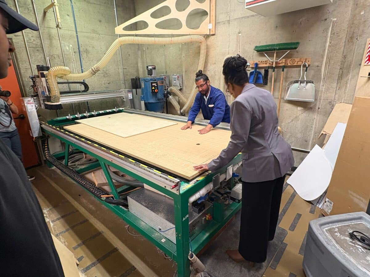 Alameda Post - Lateefah Simon examines a large workshop area.
