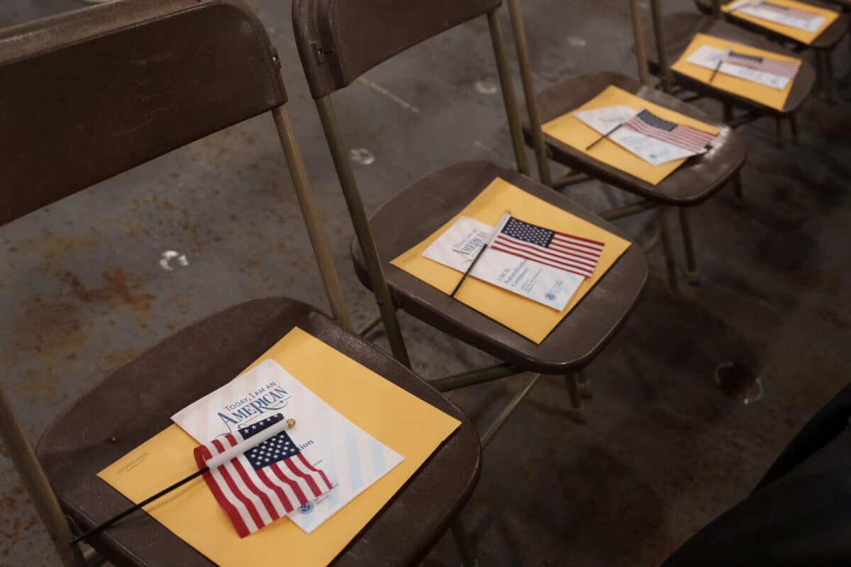 Alameda Post - Yellow envelopes, packets, and American flags are laid out on folding chairs in rows.