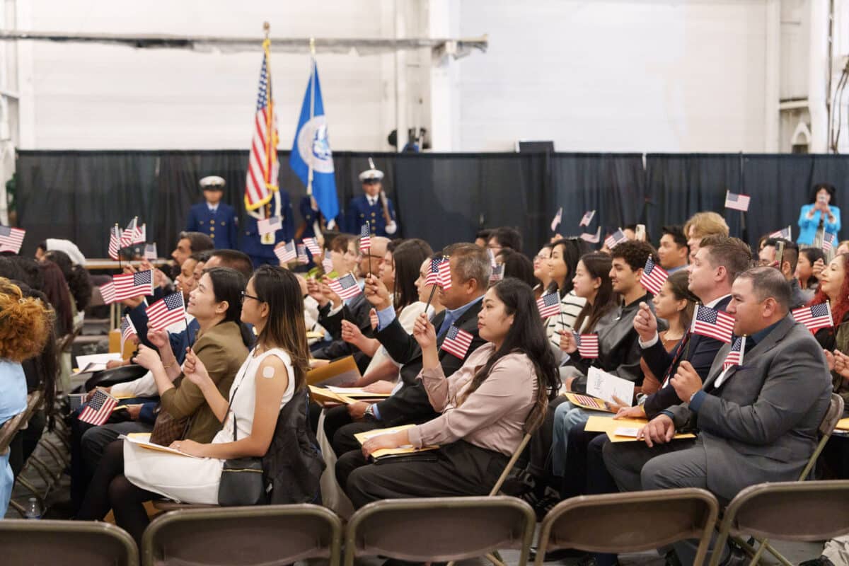 Alameda Post - A crowd of people are seated on the Hornet for the naturalization citizenship ceremony.