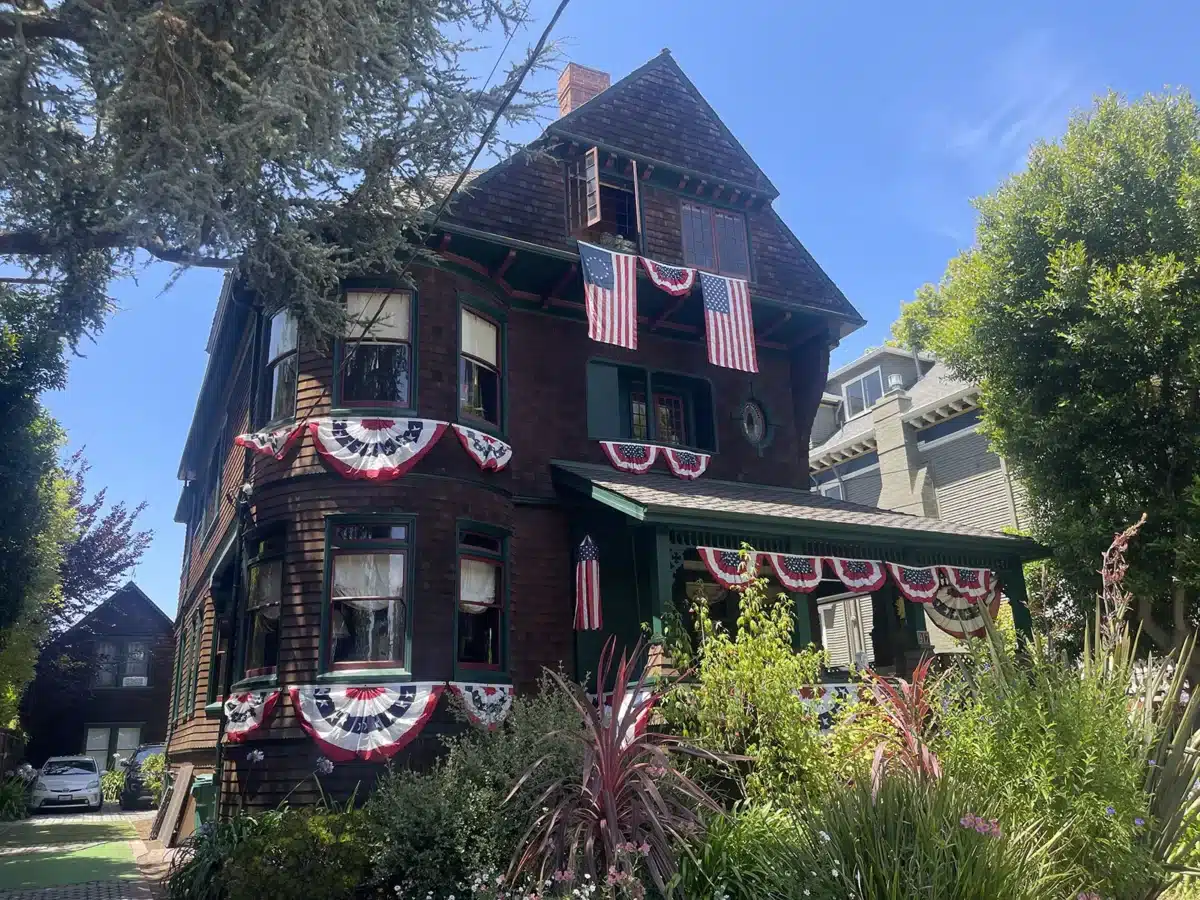 Alameda Post - A house on Grand Street with red white and blue flags and bunting. 