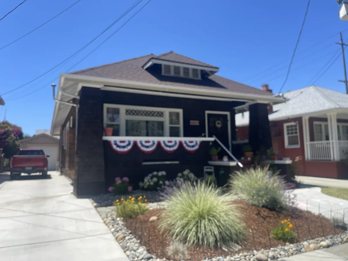 Alameda Post - A housewith red white and blue bunting. 