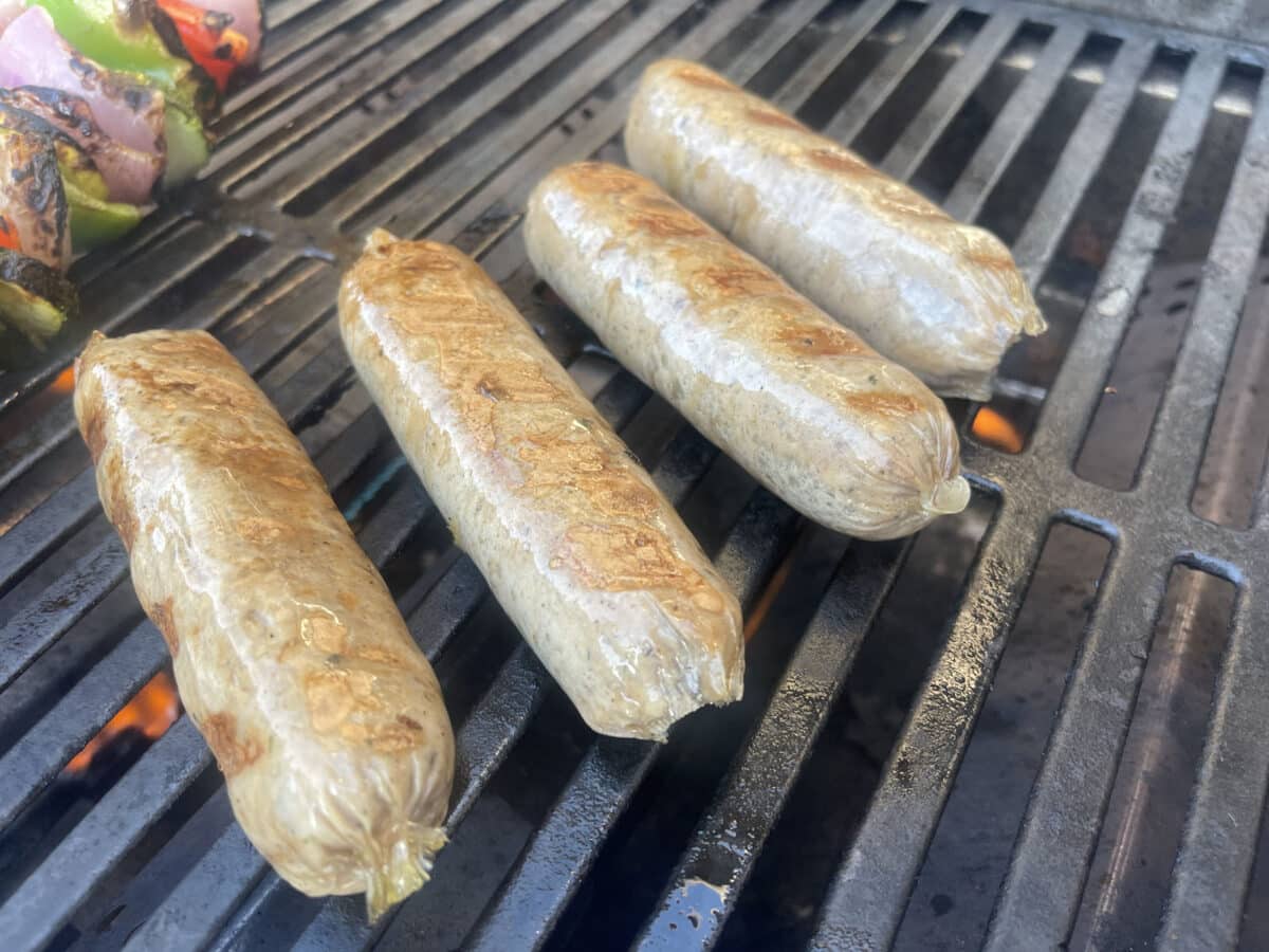 Alameda Post - Bratwursts on a grill. 