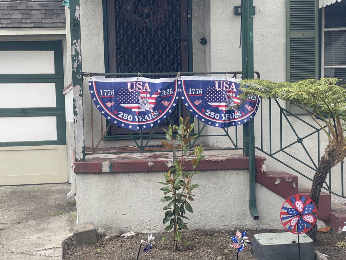 Alameda Post - Red white and blue bunting on an apartment's front step that says U.S.A. 250 Years"