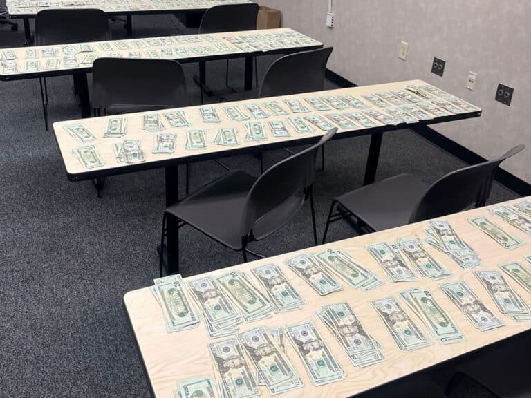 Alameda Post - tables with cash spread out over them.
