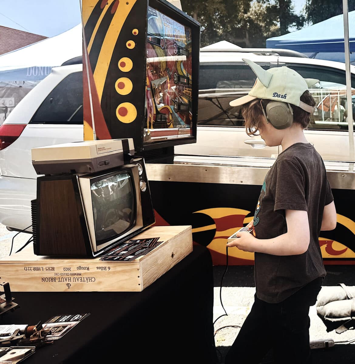 Alameda Post - A child plays a vintage game outdoors at Radio Day by the Bay.