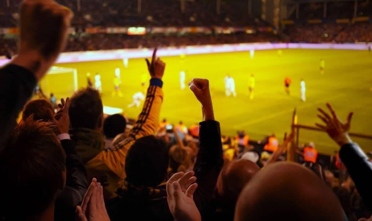 Alameda Post - Fans in a large soccer stadium cheer.