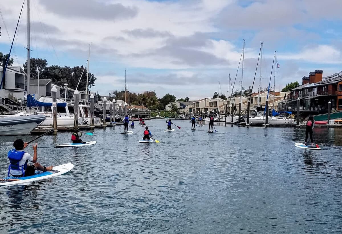Alameda Post - A photo of children on paddle boards on the Bay.