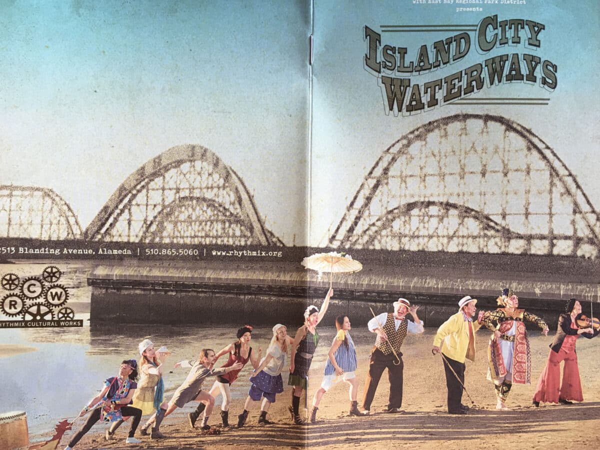 Alameda Post - A pamphlet for Island City Waterways. On the cover is a line of performers appearing to walk out of the water with a black and white roller coaster from Neptune Beach composed in the background. 
