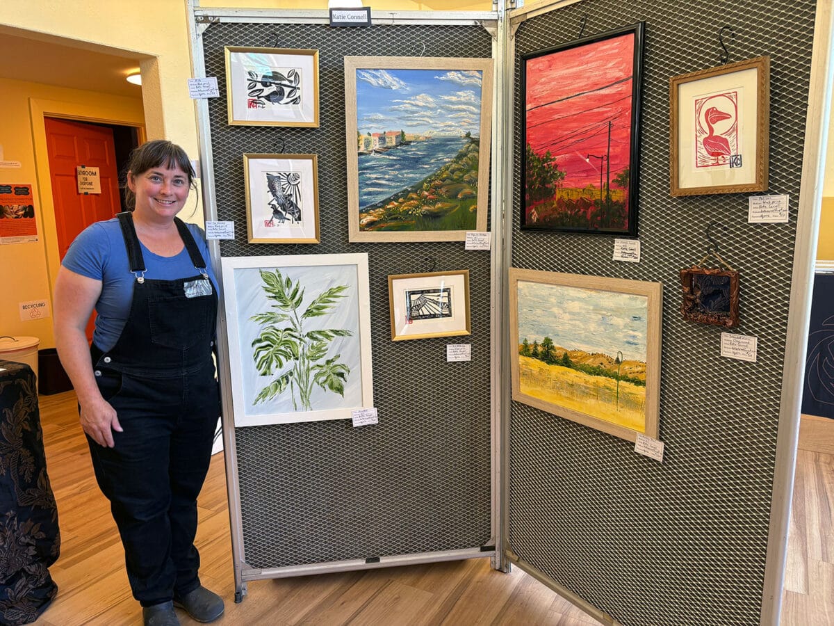 Alameda Post - a woman stands next to artworks she made