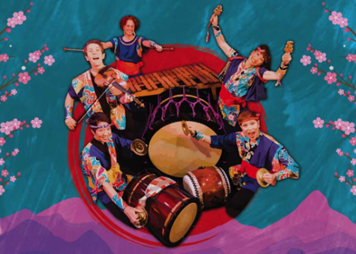 Alameda Post - A group of percussion instrument players in a circle. They smile and raise mallets and instruments. 