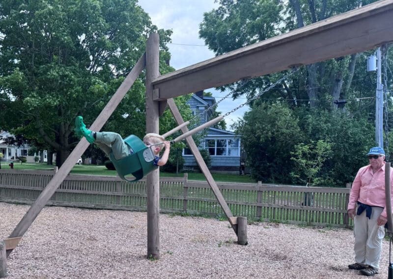 Alameda Post - A photo of a child playing on a swingset.