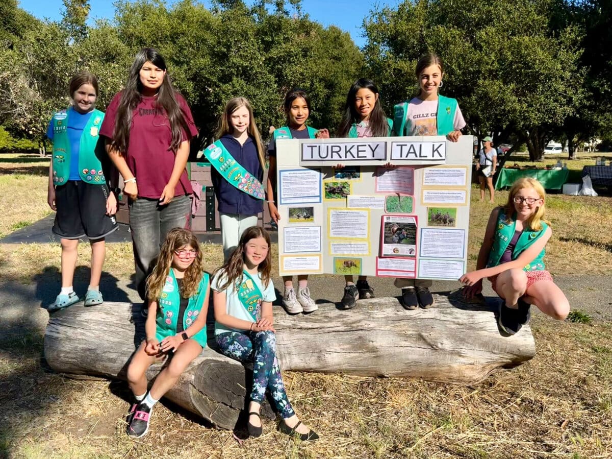 Alameda Post - Girl Scout Troop 33930 pose with a poster about turkeys. 