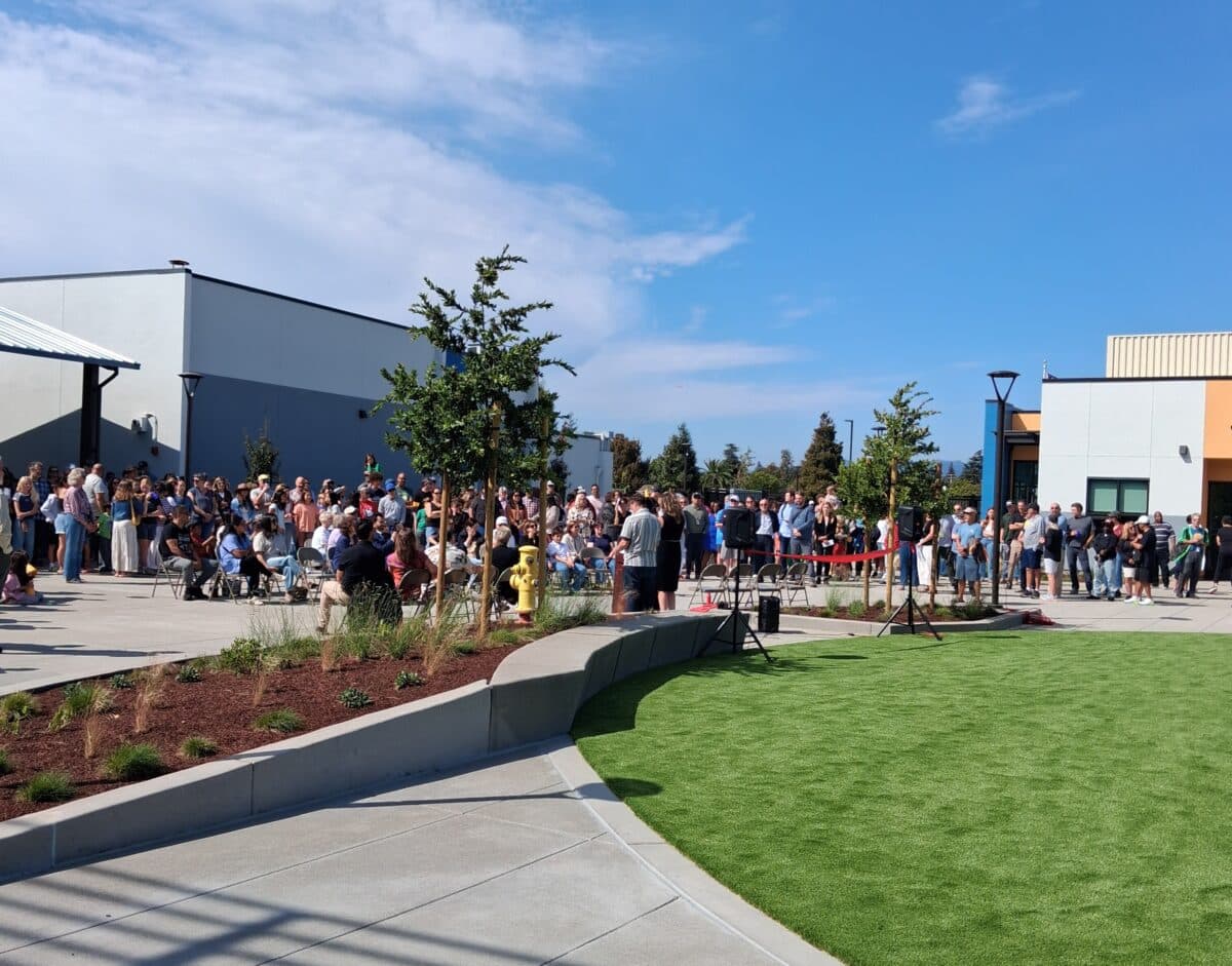 Alameda Post - A crowd gathers in a courtyard outside a school.
