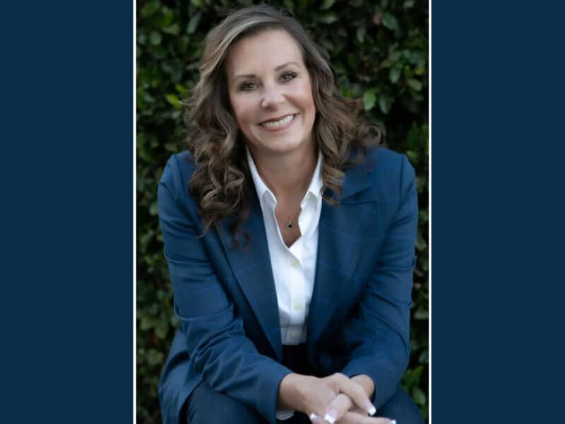 Alameda Post - Jennifer Williams smiles in a professional portrait. She is wearing a blue suit.