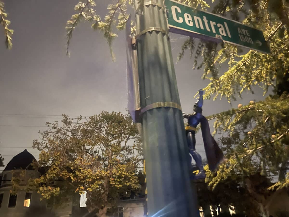 Alameda Post - A batman action figure clings to a light post.