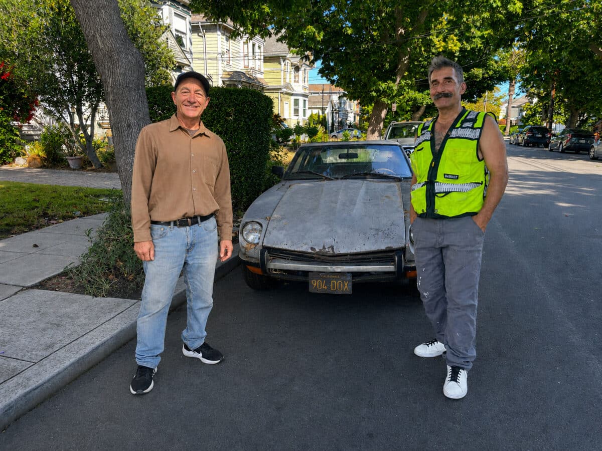 Alameda Post - Two men stand in front of a 1971 Datsun 240 Z and smile.