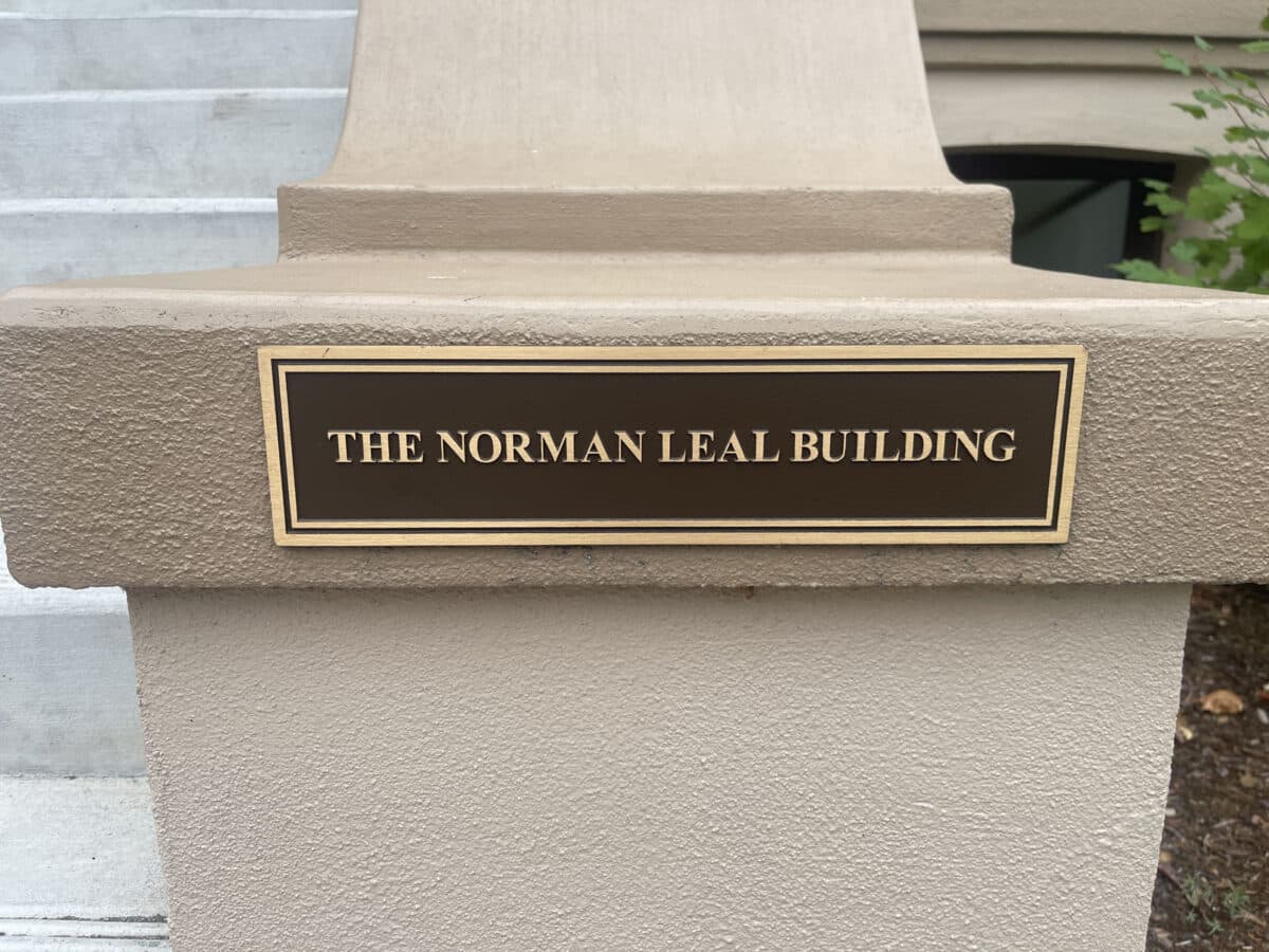 Alameda Post - A plaque on the front railing of a staircase that says The Normal Leal Building.