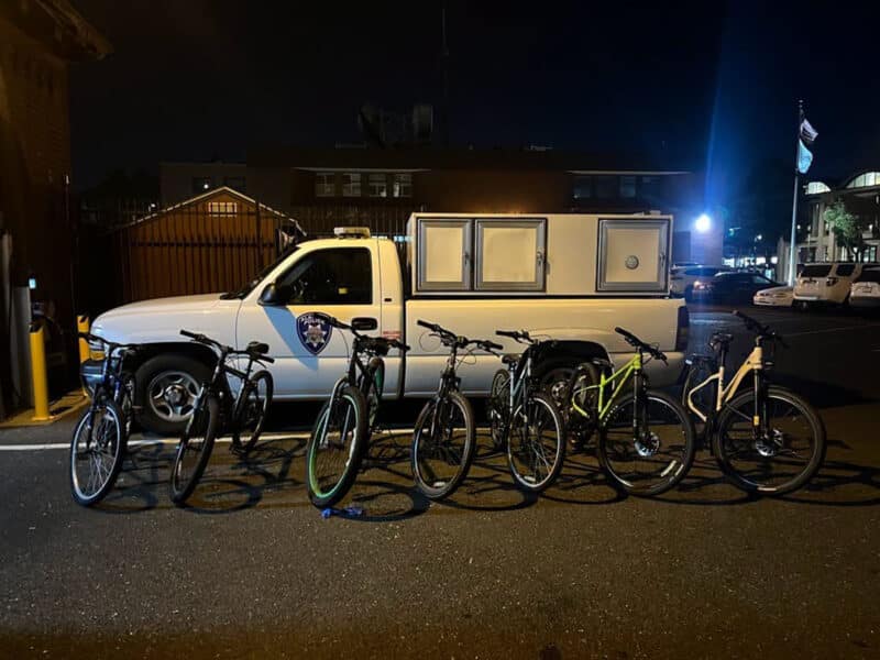 Alameda Post - An A.P.D. vehicle with a row of bicycles in front of it.