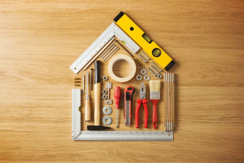 Alameda Post - A stock photo of home improvement tools arranged into the shape of a house.