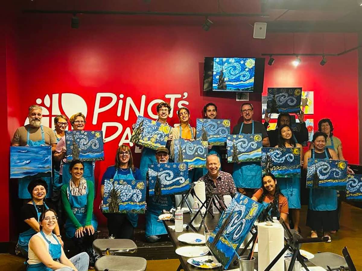 Alameda Post - a group of people holding artwork they created