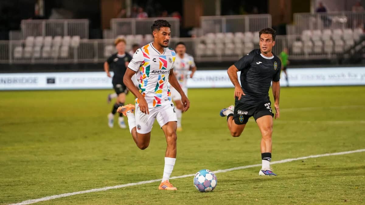 Alameda Post - An Oakland Roots player goes for the ball in a match against Las Vegas Lights FC.