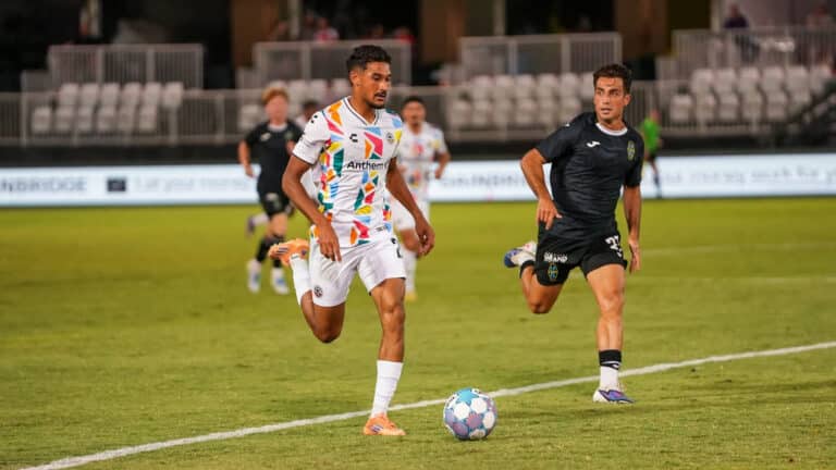 Alameda Post - An Oakland Roots player goes for the ball in a match against Las Vegas Lights FC.