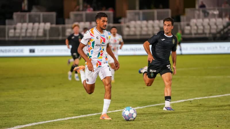 Alameda Post - An Oakland Roots player goes for the ball in a match against Las Vegas Lights FC.