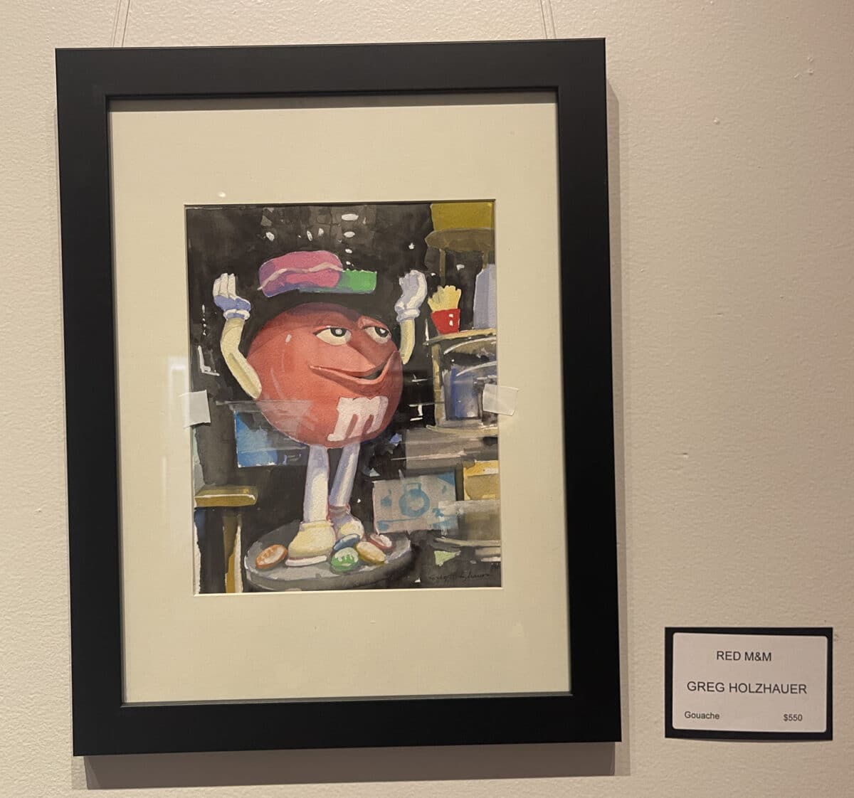 Alameda Post - A painting of a large red M&M character in a shop window.